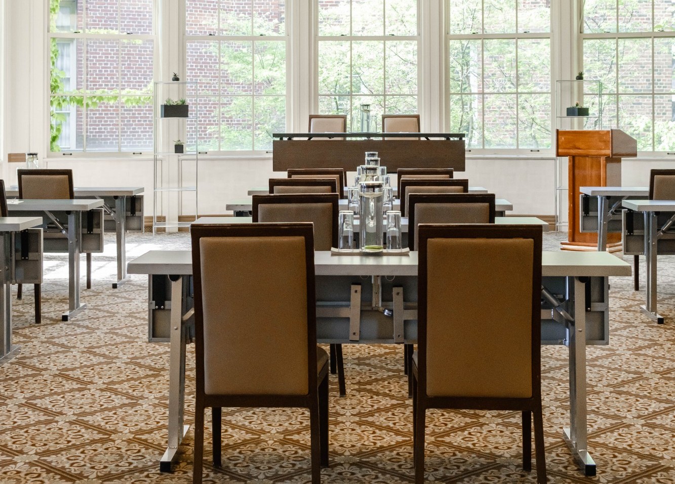A meeting room at Faculty House with bright light shining through windows in the foreground.
