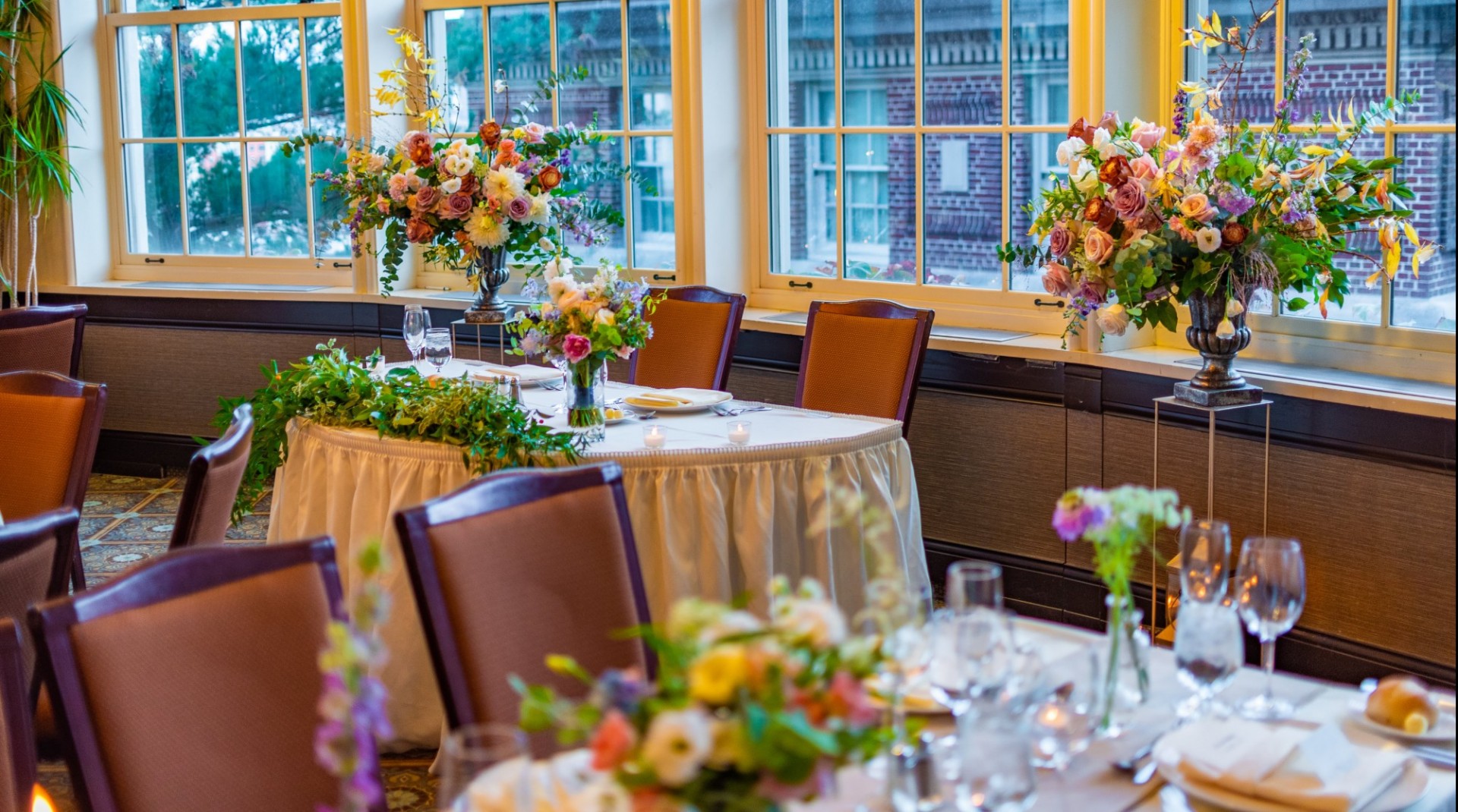 Showcase your unique style with bespoke decor. Colorful flowers adorn the sweetheart table