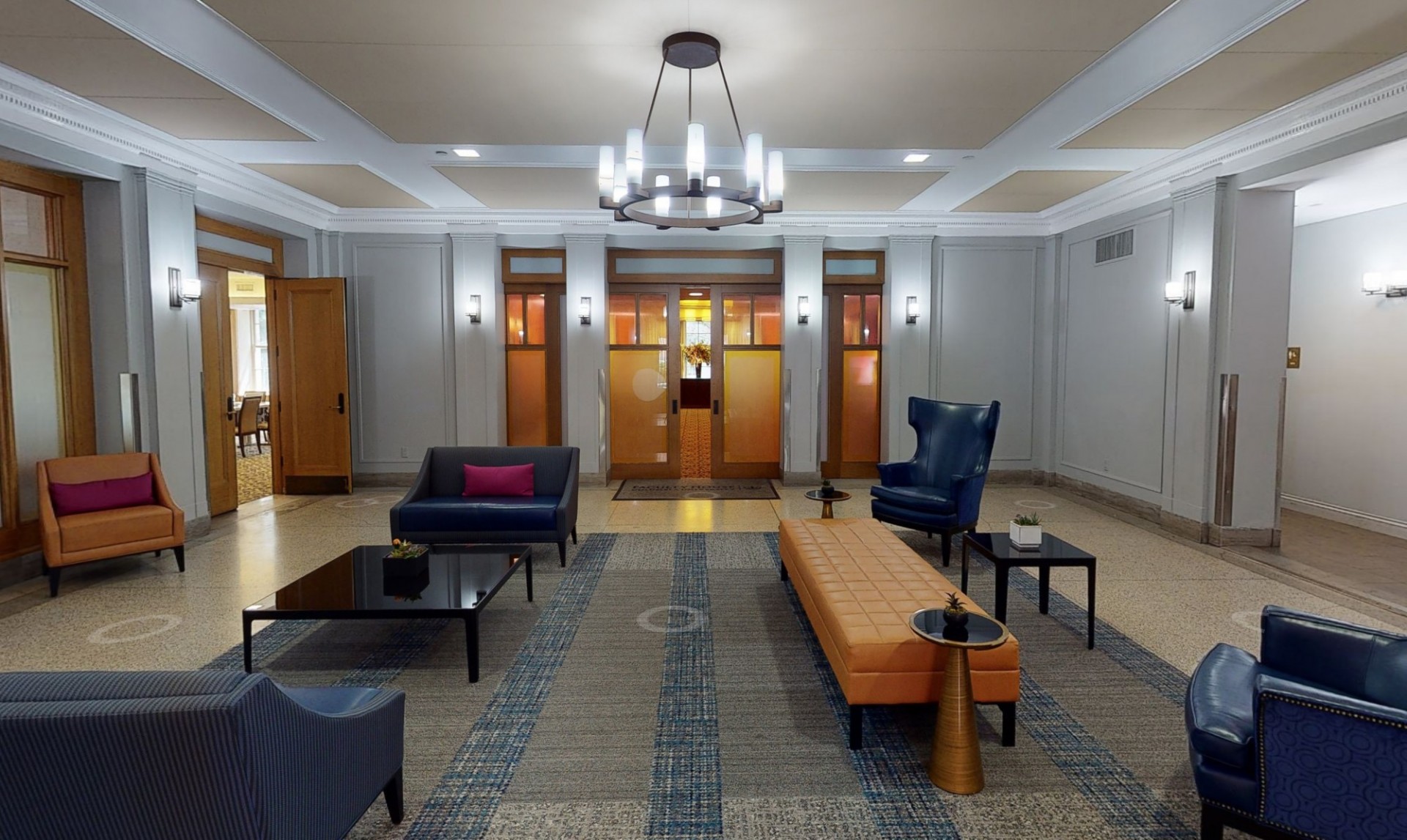 Entering the Garden Level at Faculty House with beautiful blue leather chairs, and golden-tinted glass everywhere.