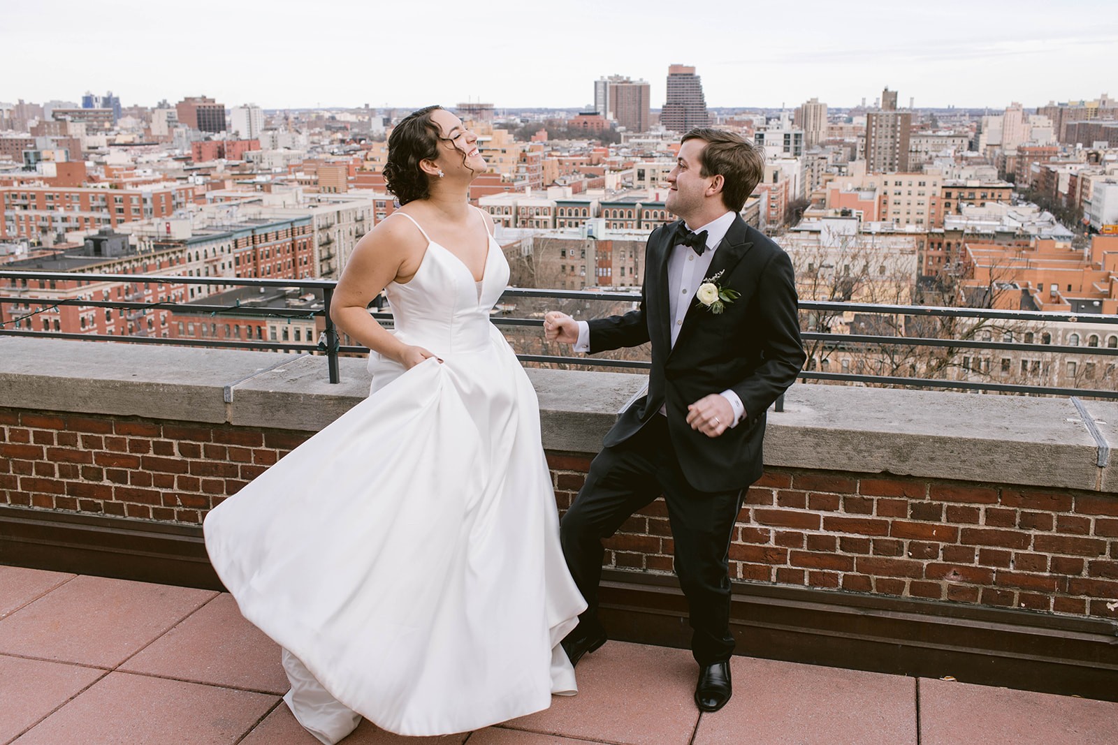 A bride and groom dance together on the Skyline Terrace at Faculty House.