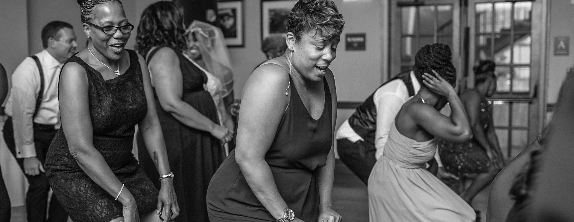 A group line dancing at a party at Faculty House