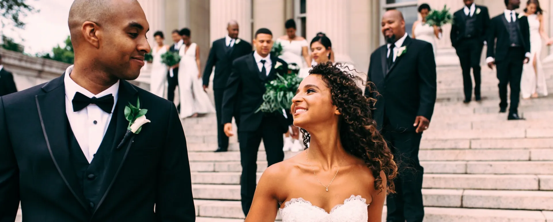 A couple walking down the stairs out of Low Library at Columbia after being married.
